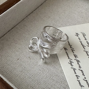 Textured S925 sterling silver bow knot open ring with a small crystal detail