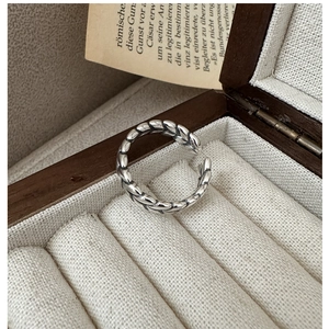 Detail of vintage S925 sterling silver wheat ear ring on a premium jewelry display