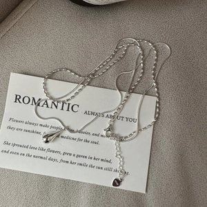 Minimalist S925 sterling silver necklace featuring a teardrop pendant and layered chain