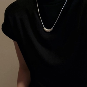 Minimalist S925 sterling silver curved snake bone necklace with matte finish on black fabric