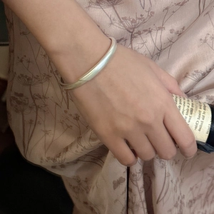 Minimalist matte S925 sterling silver cuff bracelet with cross overlap design on wrist