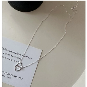 Detail of S925 sterling silver double heart necklace on an aesthetic lifestyle background