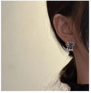 Close-up of S925 silver cloud earrings with hanging pearl raindrops on a female model