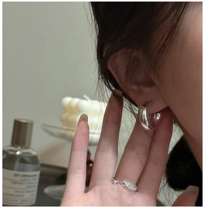 Detailed view of polished S925 sterling silver chunky C-shaped hoop earrings for women
