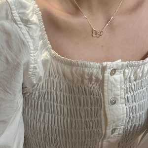 S925 sterling silver interlocking heart necklace on woman's neck for elegant look
