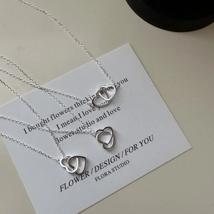 Minimalist S925 sterling silver necklace featuring an interlocking double heart pendant