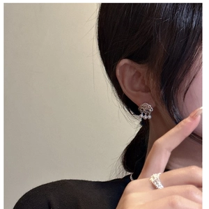 Detail of silver cloud earrings with dangling pearls worn on model for elegant style