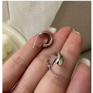 Close-up of S925 sterling silver hoop earrings showing the metal hallmark and polished finish