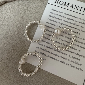 Minimalist S925 silver beaded rings set with unique baroque pearls on felt background