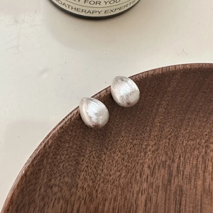 Minimalist S925 sterling silver drop earrings with brushed matte finish on wooden tray