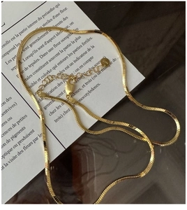 Detail of gold S925 sterling silver flat snake chain with lobster clasp and tag
