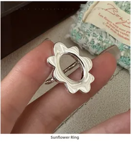 Detail of S925 silver plumeria flower ring featuring minimalist hollow petal design