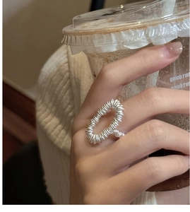 Close-up of S925 sterling silver ring featuring an artistic spiral wire-wrapped oval design