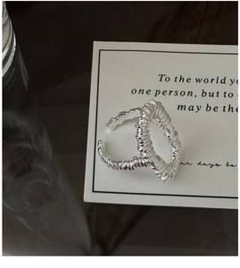 Detail shot of a S925 sterling silver open ring with a modern spiral textured design