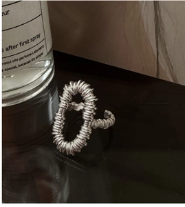 Detailed view of large oval S925 silver ring featuring a unique spiral texture design