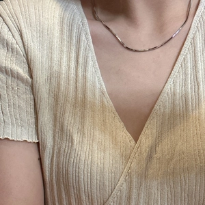 Minimalist 925 sterling silver square snake chain necklace on model neck with V-neck top