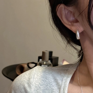Classic silver S925 sterling silver croissant hoop earrings worn for a stylish look