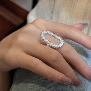 Minimalist textured S925 sterling silver chunky wrap ring worn on finger in lifestyle setting