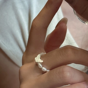 S925 silver butterfly ring with freshwater pearls on model's hand in minimalist style