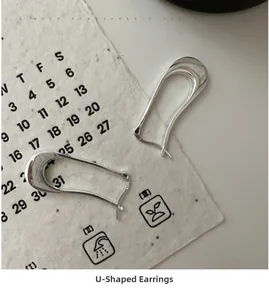 Detailed close-up of S925 sterling silver U-shaped hoop earrings with polished finish