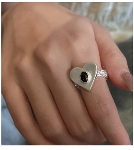 Detail of S925 sterling silver frosted heart ring with oval black onyx gemstone inlay
