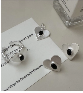 Detail of S925 silver matte heart jewelry set with black onyx and textured finish