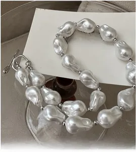 Detail of S925 sterling silver baroque pearl necklace with T-bar clasp and silver beads