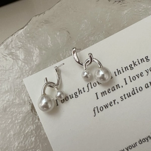 Elegant S925 sterling silver crossed pearl stud earrings on a clean white paper base