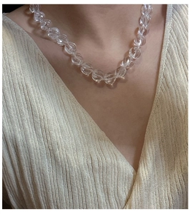 Close-up of S925 silver necklace featuring transparent pumpkin-shaped carved crystal beads