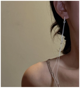 Close-up of minimalist S925 silver tassel drop earrings on a model for a chic look
