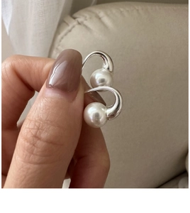 Close-up of elegant S925 sterling silver pearl earrings with a sleek minimalist design