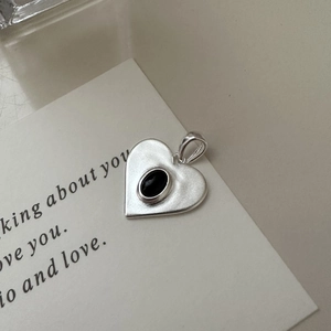 S925 sterling silver matte heart pendant with oval black gemstone on white card
