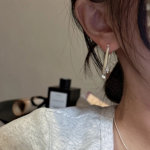 Polished S925 sterling silver U-shaped hoop earrings on a model for a modern minimalist look