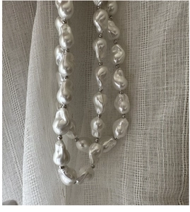 Close-up of S925 silver necklace with baroque pearls and small metallic spacer beads
