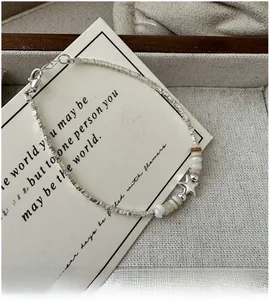 Detailed shot of S925 silver star bracelet with mother-of-pearl beads and square links