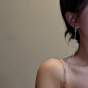 Elegant S925 sterling silver long tassel drop earrings worn by model in minimalist style