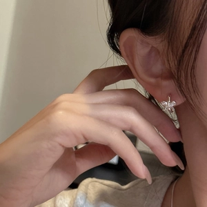Elegant S925 sterling silver five-petal flower stud earrings worn on a model's ear