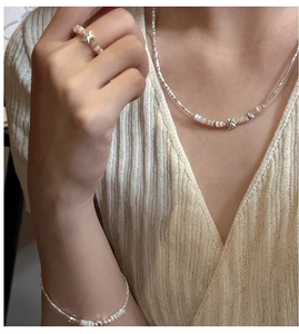 Detail of S925 silver star jewelry set with necklace, bracelet and ring on model