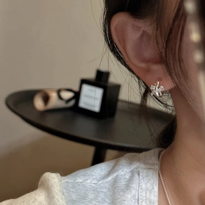Elegant S925 sterling silver bow earrings on model with minimalist retro aesthetic style
