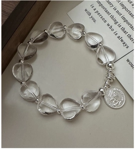 Close-up of S925 silver beaded bracelet with heart crystals and coin portrait charm