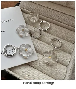 Close-up of S925 silver flower hoop earrings with resin petals in a jewelry box