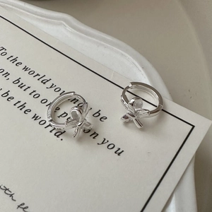 Minimalist S925 sterling silver bow knot hoop earrings on a vintage aesthetic card