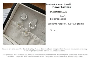 Detail of S925 sterling silver hoop earrings with clear resin daisy floral charms
