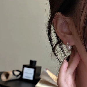 Elegant S925 sterling silver pearl hook earrings worn by model in a minimalist style