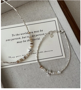 Detail of S925 sterling silver star pendant necklace and bracelet set on a display tray