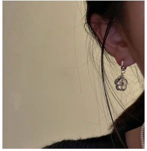 Close-up of S925 sterling silver hoop earrings with translucent frosted flower charms