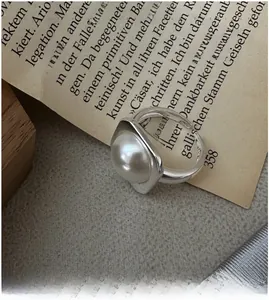 Macro shot of minimalist S925 sterling silver ring with large white Mabe pearl detail