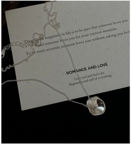 Close-up of S925 sterling silver necklace with irregular molten pendant and hallmark