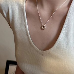 Minimalist S925 sterling silver necklace with irregular geometric pendant on a model
