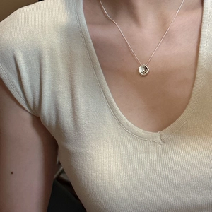 Minimalist S925 sterling silver necklace with irregular pendant worn by model on V-neck top